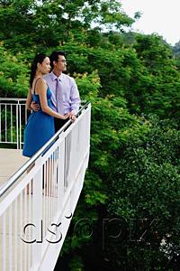 AsiaPix - Couple standing on balcony, side view