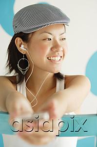 AsiaPix - Young woman wearing beret, listening to MP3 player