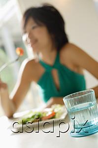 AsiaPix - Young woman eating salad, selective focus