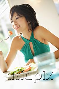 AsiaPix - Young woman eating salad, selective focus