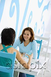 AsiaPix - Young women in cafe, sitting face to face