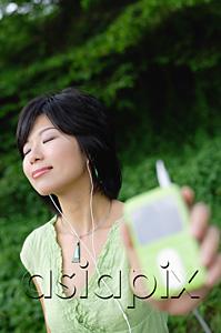 AsiaPix - Young woman listening to mp3 player, eyes closed