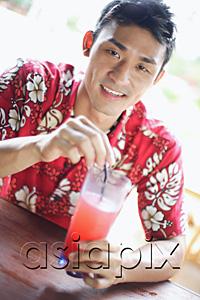 AsiaPix - Man wearing floral shirt, holding a drink, looking at camera