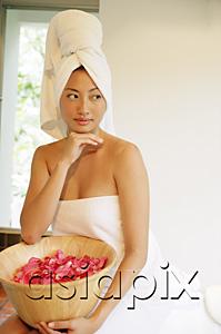AsiaPix - Woman in towel, holding bowl filled flower petals, hand on chin