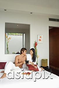 AsiaPix - Couple sitting on bed, toasting with mugs