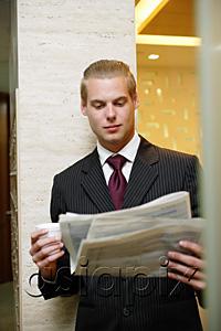 AsiaPix - Businessman reading newspaper