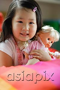 AsiaPix - Girl holding a doll, looking at camera