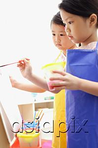 AsiaPix - Young girls painting on easel