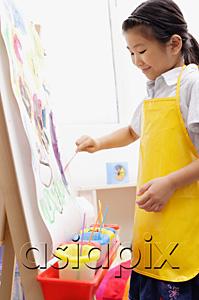 AsiaPix - Young girl in yellow apron,  painting on easel