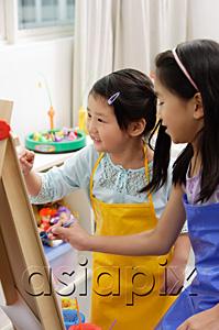 AsiaPix - Two girls painting on easel