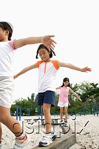 AsiaPix - Girls walking on balance beams, arms outstretched