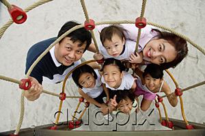 AsiaPix - Family at playground, smiling at camera, high angle view