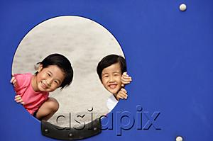 AsiaPix - Two girls in playground, looking through hole