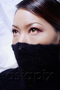 AsiaPix - Young woman with turtleneck pulled up over half of face, looking away