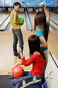 AsiaPix - Women in bowling alley, one woman about to bowl, friends cheering her on