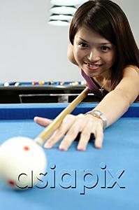 AsiaPix - Woman with pool cue, aiming at ball