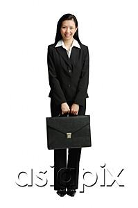 AsiaPix - Businesswoman standing with briefcase, looking at camera