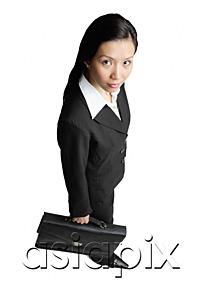 AsiaPix - Businesswoman holding briefcase, looking at camera