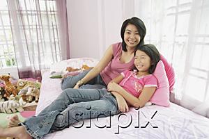 AsiaPix - Mother and daughter in bedroom, side by side, looking at camera