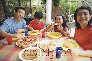 AsiaPix - Family of four having pizza at home