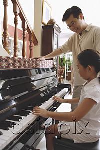 AsiaPix - Father watching daughter playing the piano