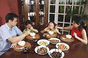 AsiaPix - Family of four having dinner at home