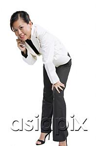 AsiaPix - Woman with mobile phone, bending forward