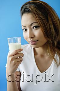 AsiaPix - Woman holding a glass of milk