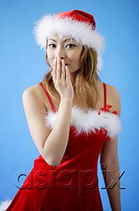 AsiaPix - Woman wearing Santa hat and red dress, hand covering mouth