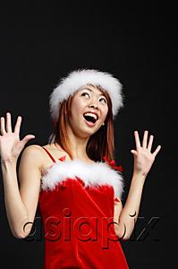 AsiaPix - Woman wearing Santa hat and red dress, mouth open in surprise