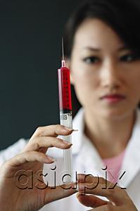 AsiaPix - Female doctor holding syringe