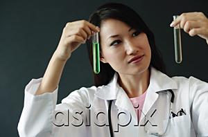 AsiaPix - Doctor holding up two test tubes