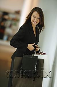 AsiaPix - Young woman with shopping bags, smiling