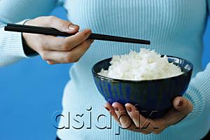 AsiaPix - Woman holding bowl of rice and chopstick