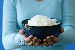 AsiaPix - Woman holding bowl of rice, cropped image