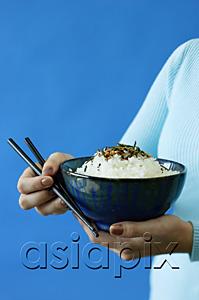 AsiaPix - Woman holding bowl of rice and chopsticks