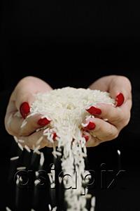 AsiaPix - Woman holding rice in cupped hands