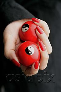 AsiaPix - Woman holding Yin Yang balls