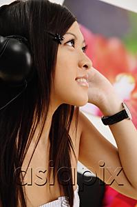 AsiaPix - Girl listening to headphones, side view