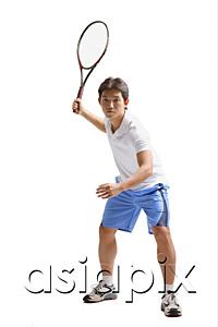 AsiaPix - Young man holding tennis racket, waiting