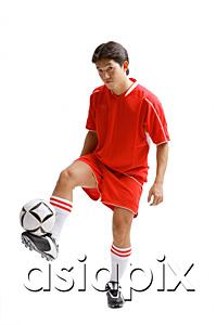 AsiaPix - Young man in soccer uniform balancing soccer ball on leg
