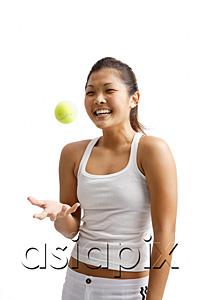 AsiaPix - Young woman tossing tennis ball