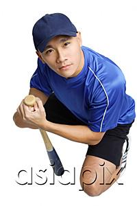 AsiaPix - Young man crouching, holding baseball bat