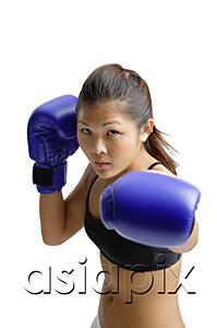 AsiaPix - Young woman wearing boxing gloves