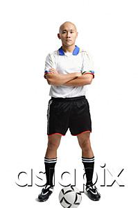 AsiaPix - Young man wearing soccer uniform, standing with arms crossed