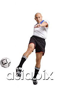 AsiaPix - Young man in soccer uniform, kicking ball