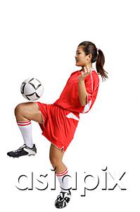 AsiaPix - Young woman in soccer uniform, balancing ball on knee