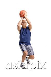 AsiaPix - Young man holding basketball, aiming