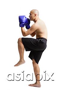 AsiaPix - Young man boxing, studio shot