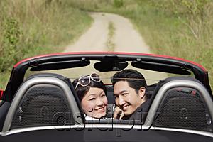 AsiaPix - Couple in convertible sports car, turning to look at camera